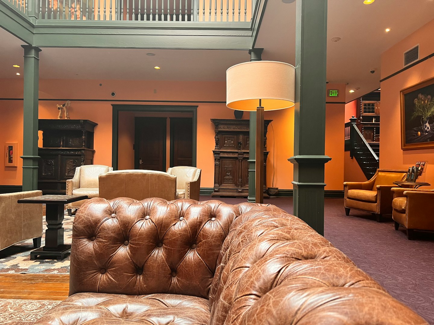 Plush leather seating in a luxurious hotel lobby with a tufted sofa.